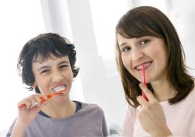 Junge und Mädchen beim Zähne putzen.