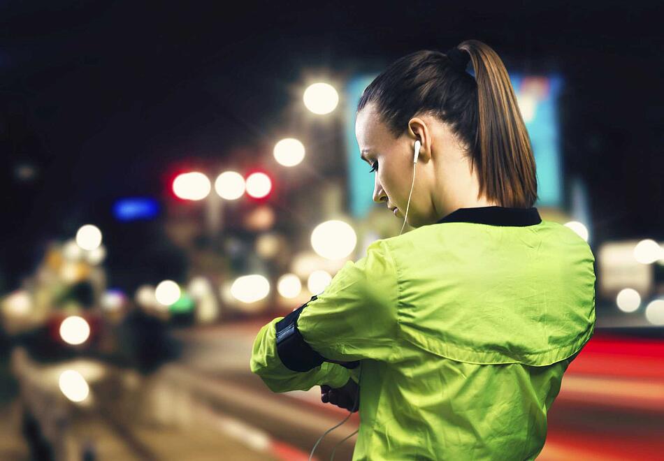 Junge Frau joggt bei Dunkelheit - Bildnachweis: © istockphoto.com / Halfpoint Junge Frau joggt bei Dunkelheit