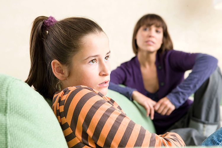 Bildnachweis: © wdv / Oana Szekely Jugendliche in schlechter Stimmung sitzt mit ihrer Mutter auf dem Sofa.